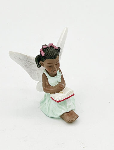 Fairy reading a book