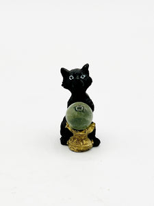 Black cat with crystal ball